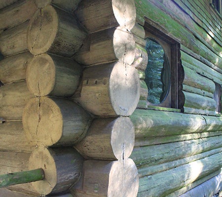 Detail of the stacked peeled logs at the Arnold Park Cabin.