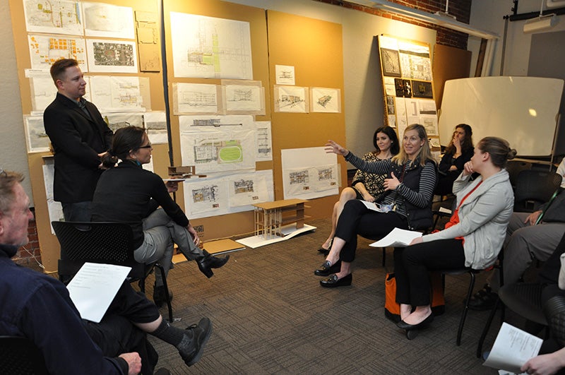 Students and reviewers discuss design concepts