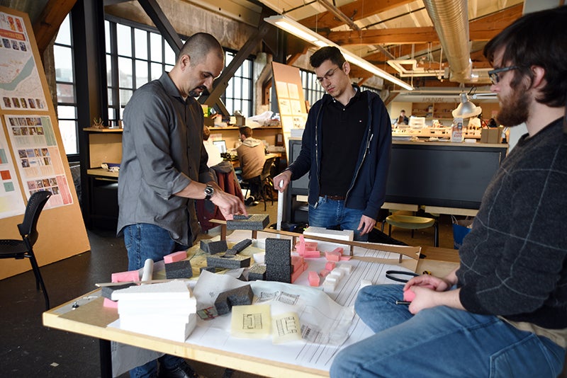 Opsis Associate Principal and studio instructor Joe Baldwin talks to students during a review of the work