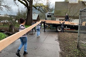 Photo of students working on house construction