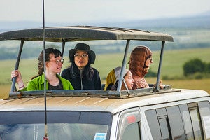 Photo of students on safari looking out from their van.