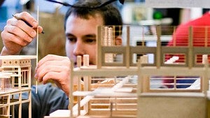architecture student builds model with wood