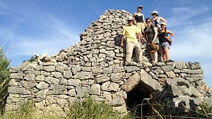 Croatia Field School students stand on stone structure