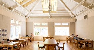 The Wilcox Hearth with vaulted ceiling, wood floor, and students studying at tables