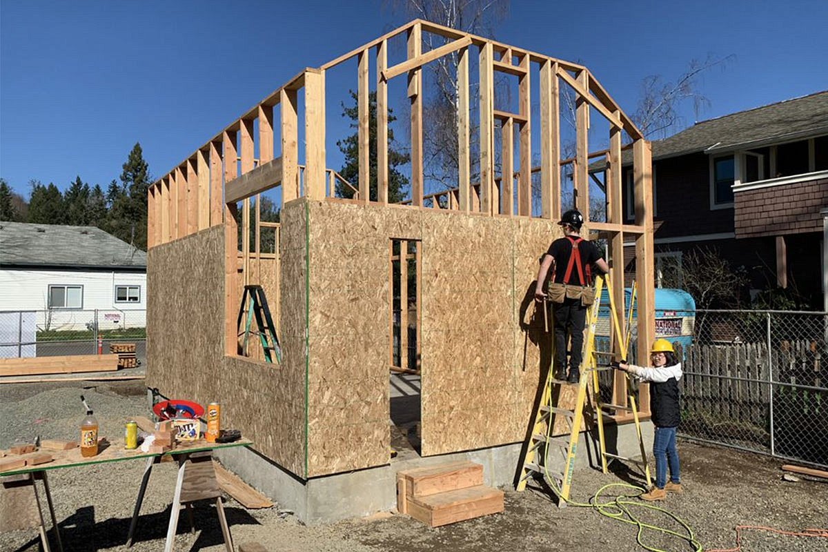 Photo of students working on house construction