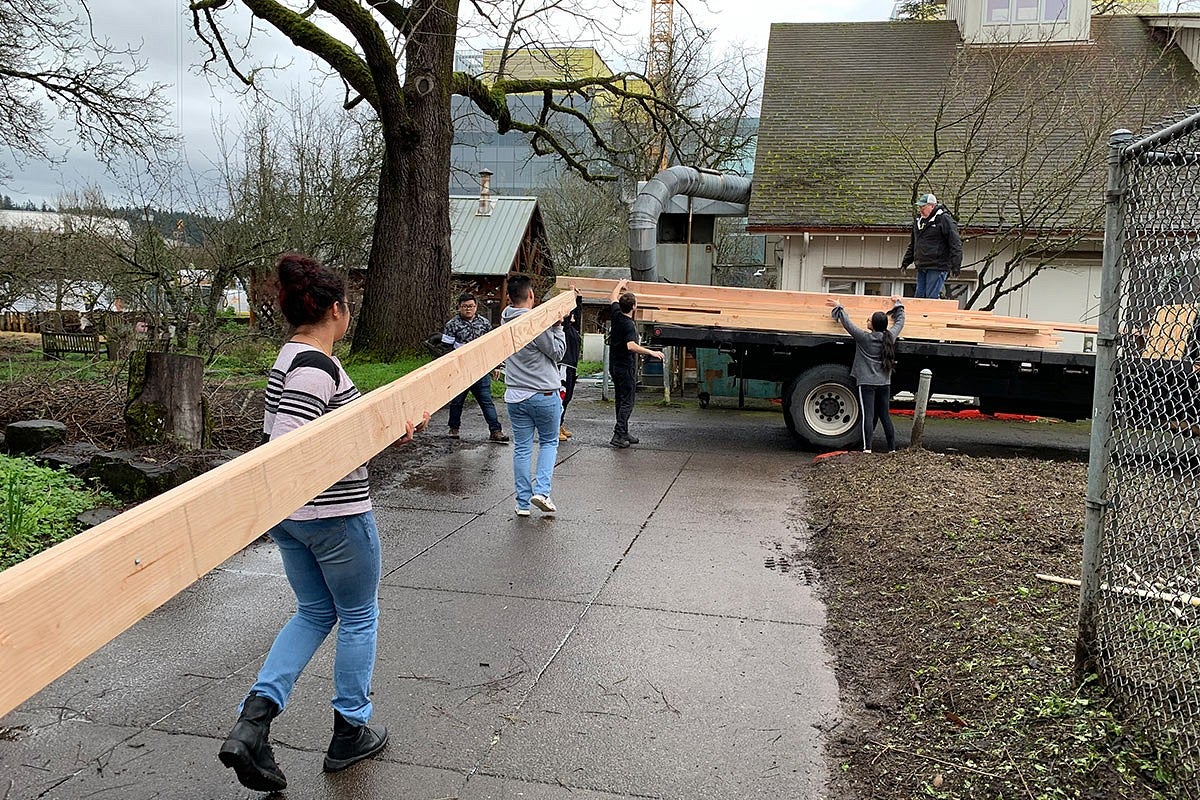 Photo of students working on house construction
