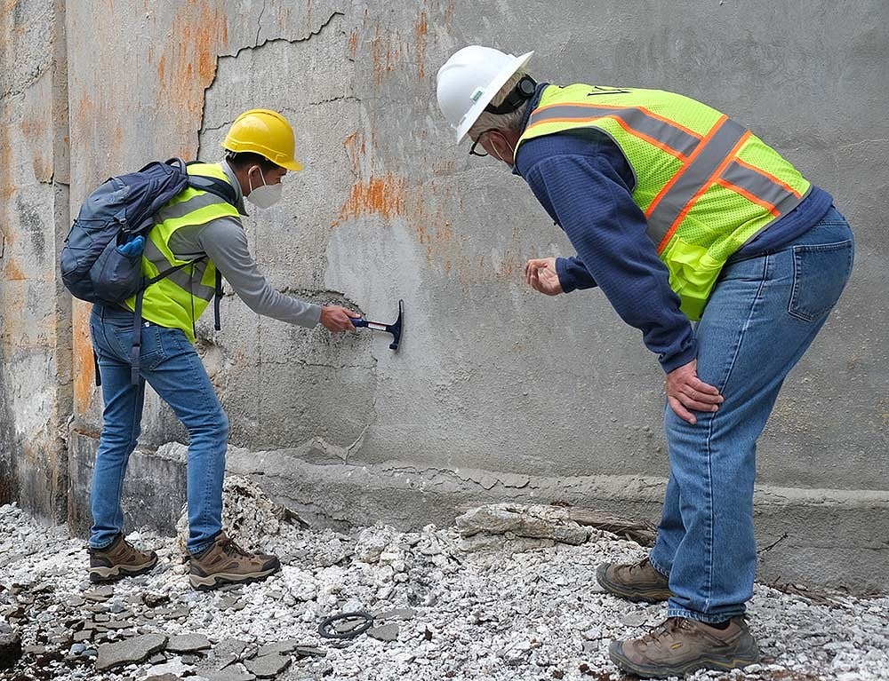 people examining concrete