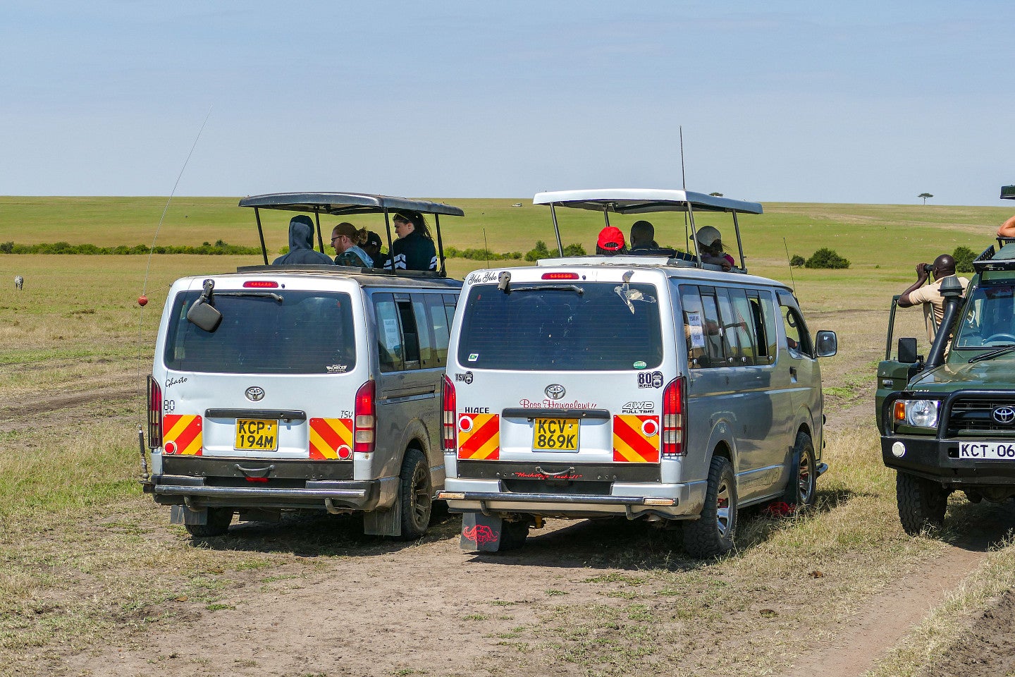 Photo of two vans on safari in Africa; filled with students