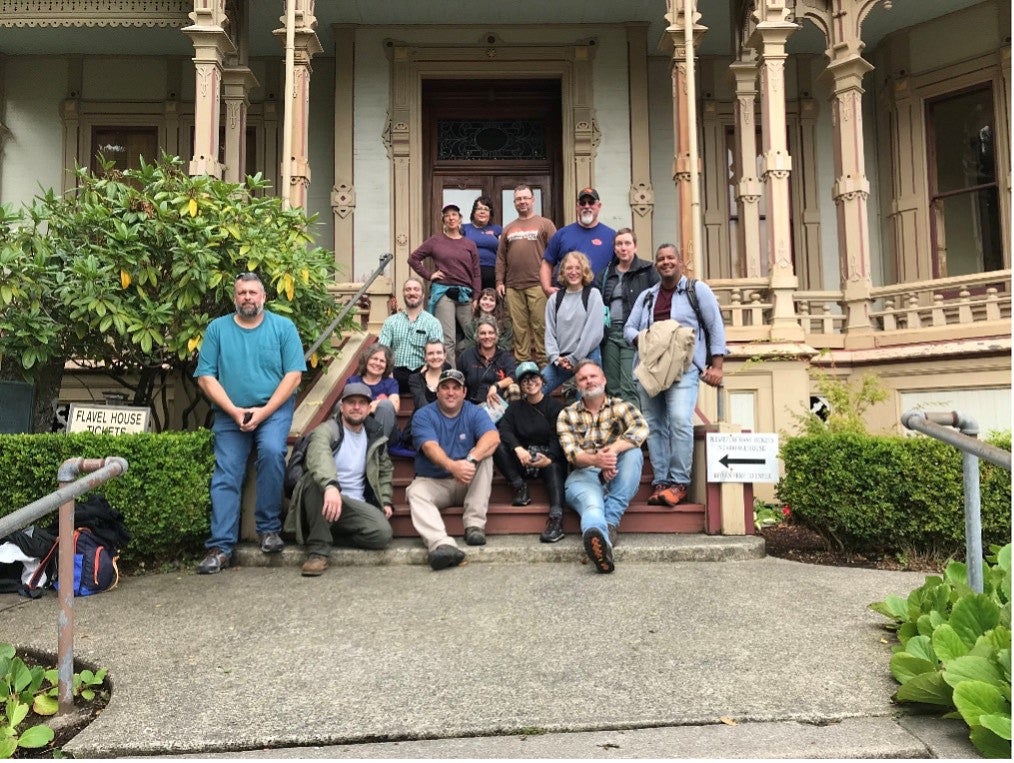 Group photo of the PNWPFS team in front of a historic home at the 2023 PNWPFS site. 