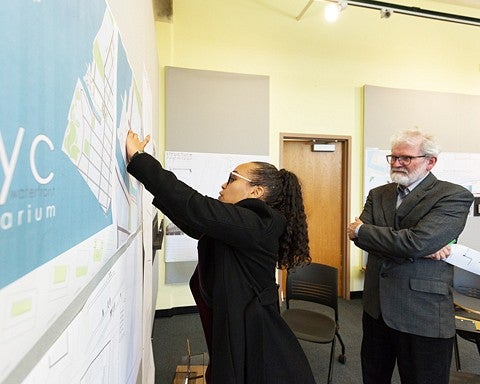 student presents work to Professor James Tice