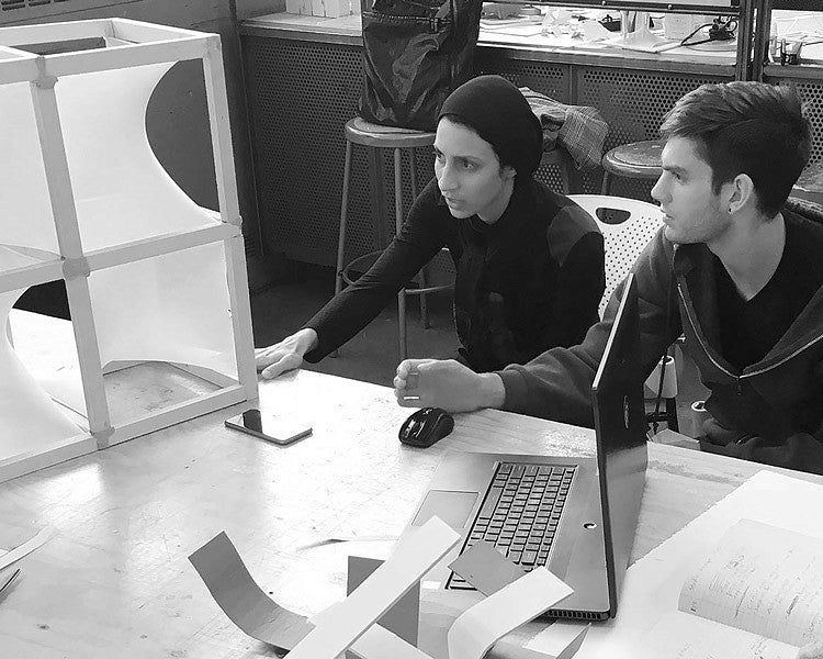 two students work on model