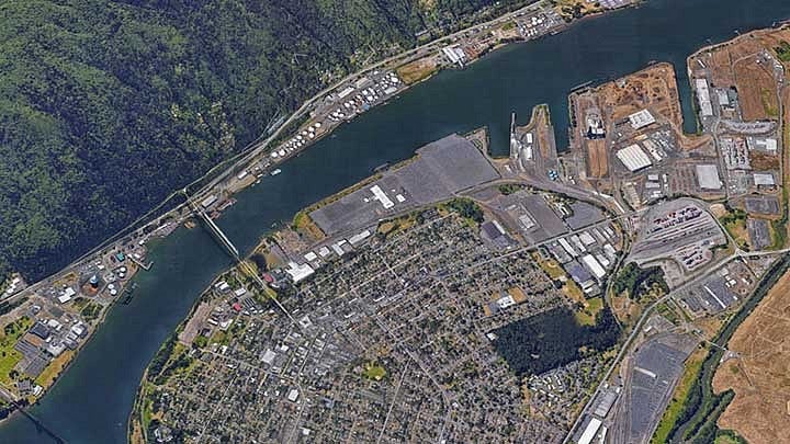 Overhead of a forest and urban area divided by a river