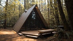 Photo of an A-frame house in a forest