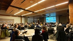 Photo of Reynolds Symposium, people in conference room