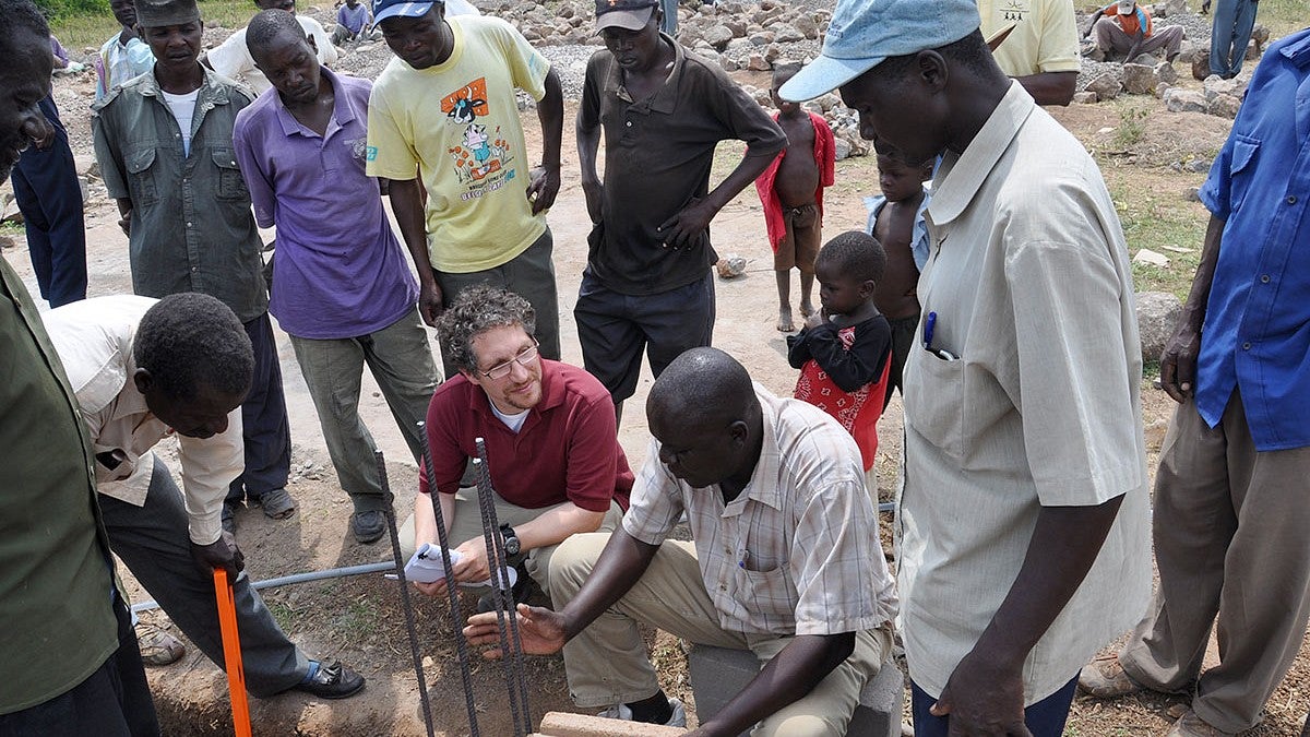 A group of people working on something outside in Tanzania