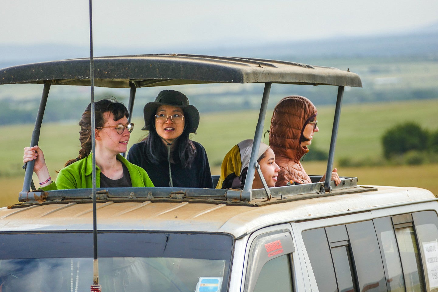 Photo of students on safari looking out from their van. 