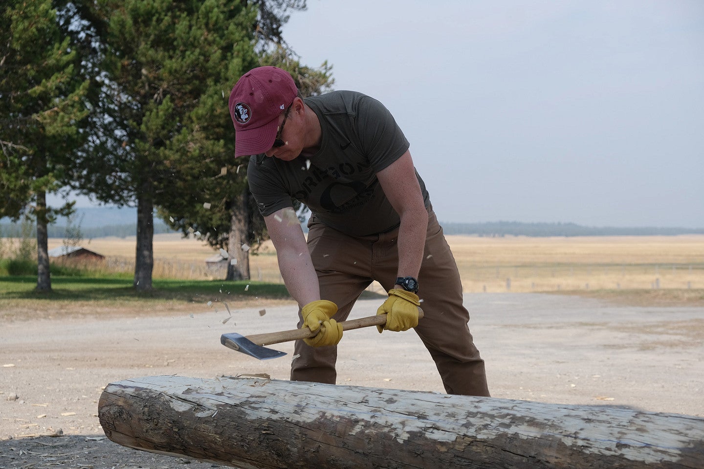 Photo from 2022 PNWPFS working on logs with one individual in the foreground. 