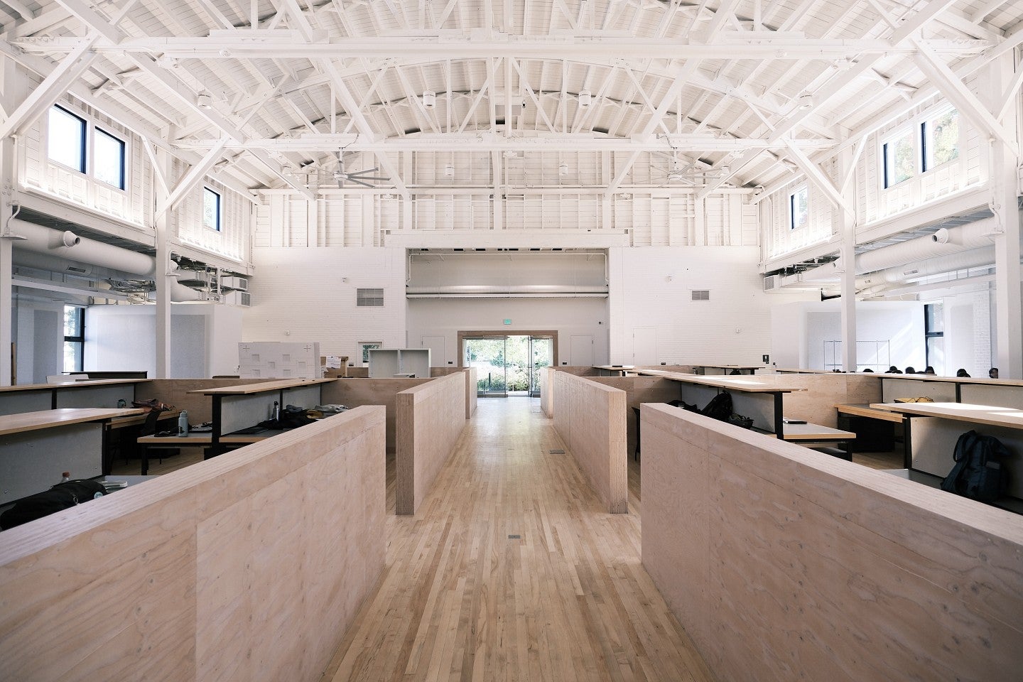 Wide angle view of Highland Hall. Shows a tall, white space with plenty of wood accents and floors. 