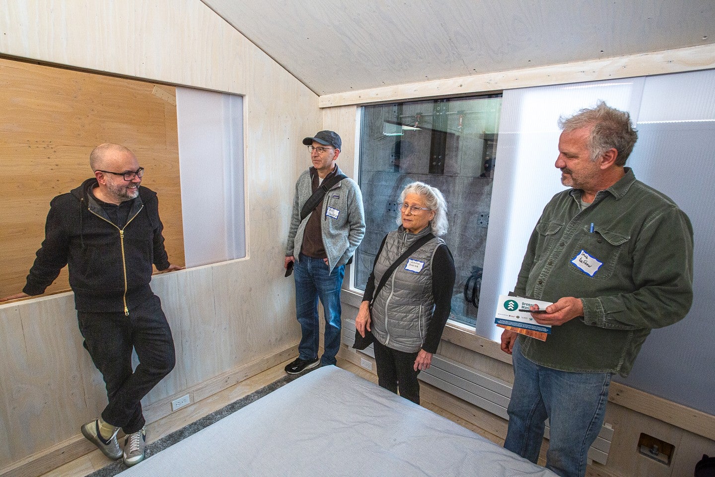 Photograph of Judith Sheine and Mark Fretz giving a tour of the MPP Workforce Housing prototype. 