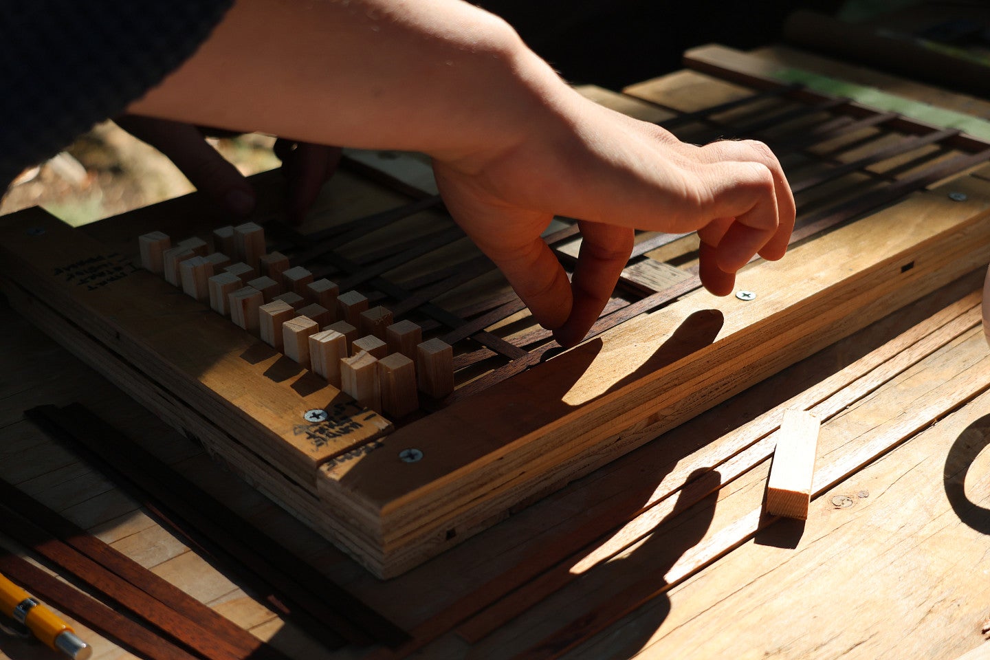 Preservationist works on a unidentifiable, intricate wood carved item. 