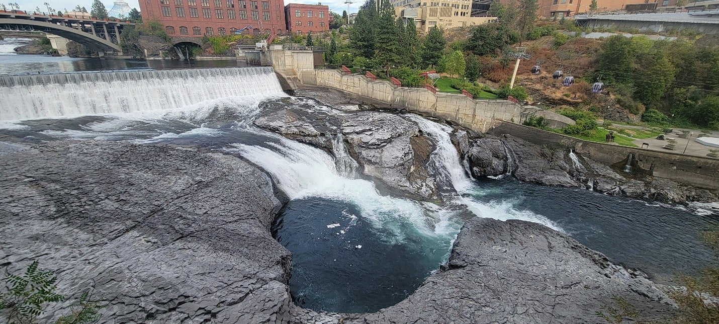 photograph of a dam and river. 