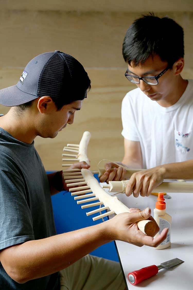 men working with wooden tool