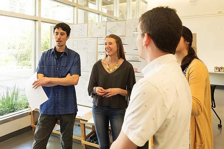 students talk while displaying work