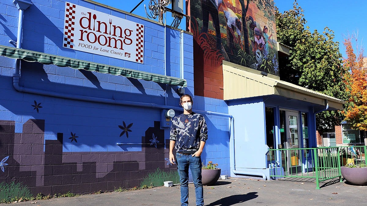 Photo of a man in front of a building