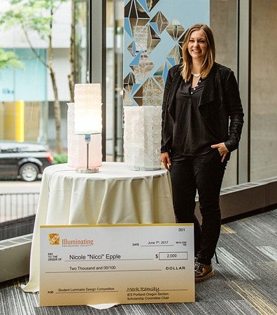 Nicole Epple with lamps and Illuminating Engineering Society of Oregon scholarship check